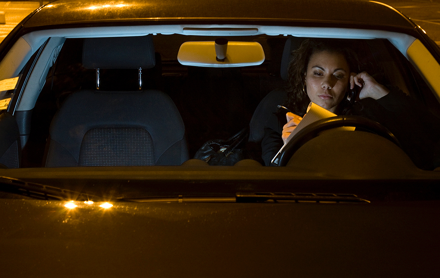 Woman at the wheel in a darkened car