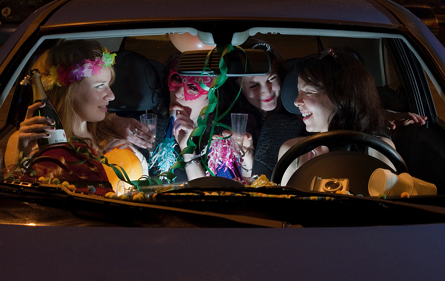 Costumed group gathered inside a car