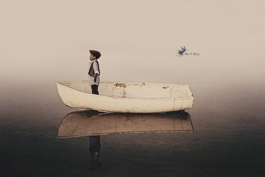 Child standing in a white boat on calm water