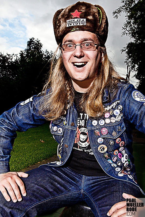 Smiling fan wearing a denim vest