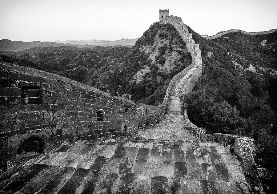 Stone wall stretching over hills in black and white