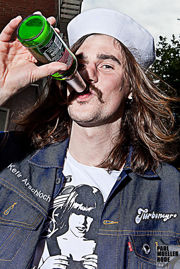 Fan drinking from a green bottle