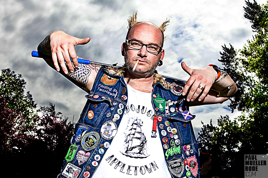 Man showing patches on his denim vest