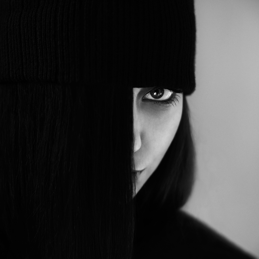 One eye visible beside a dark textured screen