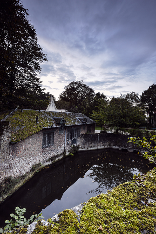 Stone bridge crossing a stream in Bruges Ommeland