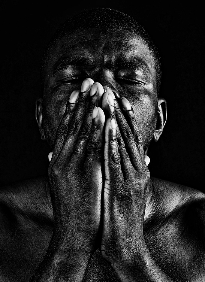 Person covering mouth with both hands