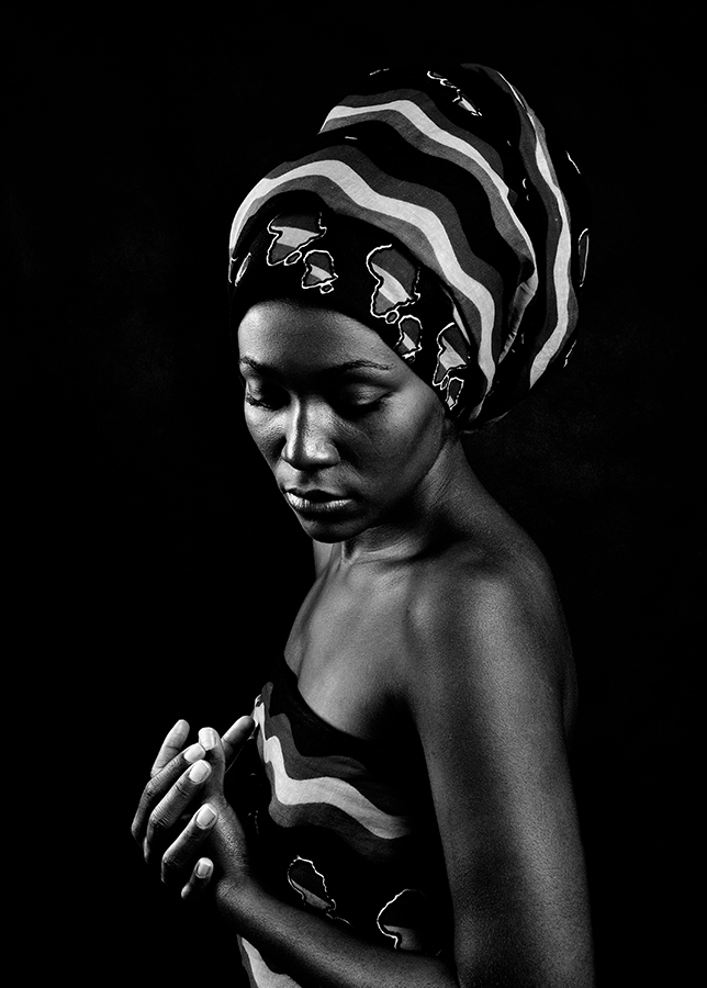 Woman in a patterned head wrap and dress