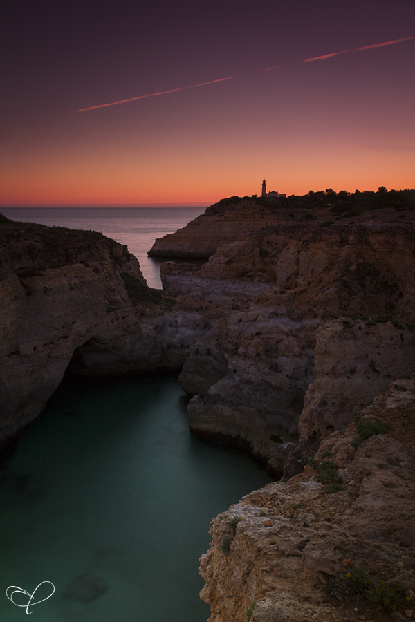 Cliffs above calm water at twilight
