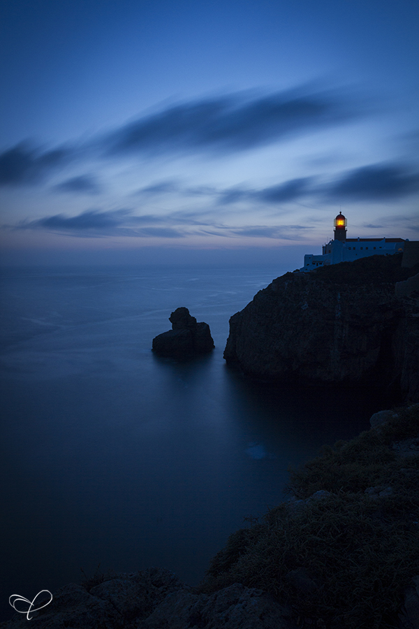 Lighthouse on a dark coastal headland