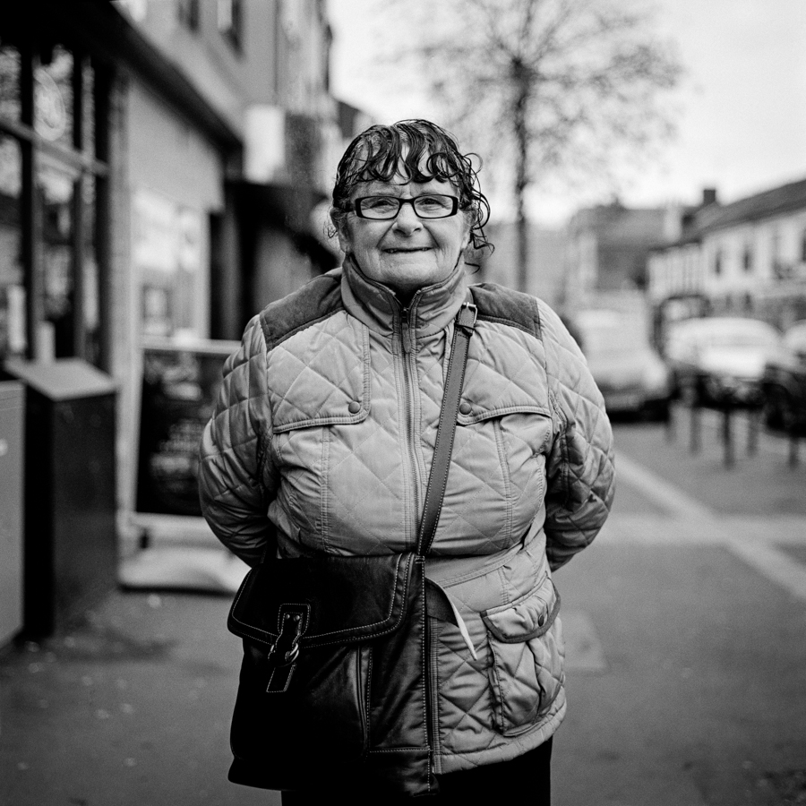 Woman with glasses on a busy street