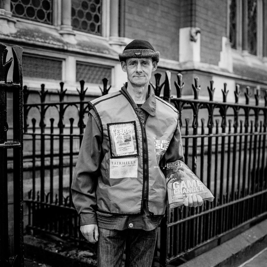 Man beside a black railing