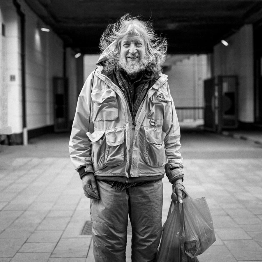 Person with long hair beneath a covered walkway