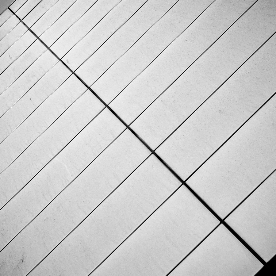 Diagonal lines across a pale facade