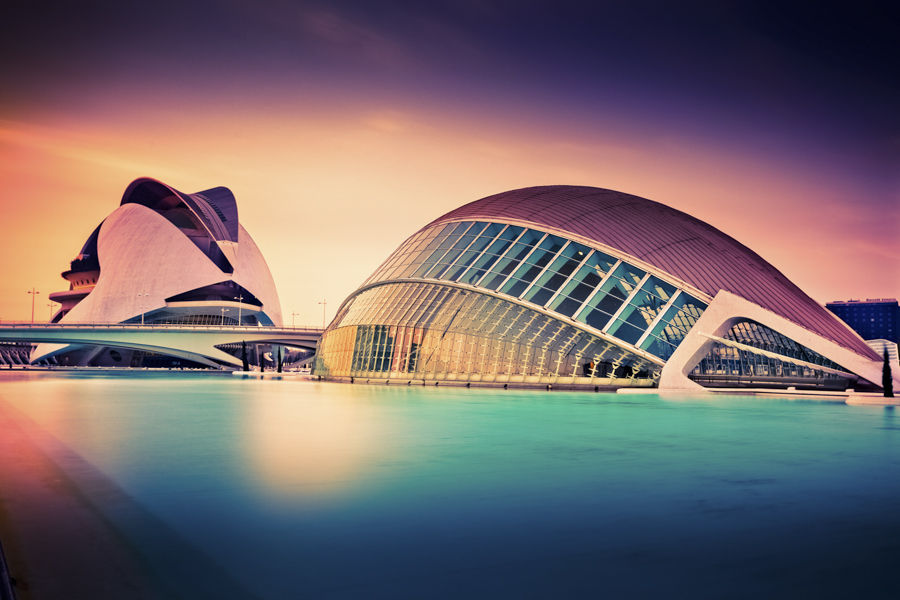 White curved buildings reflected in a pool