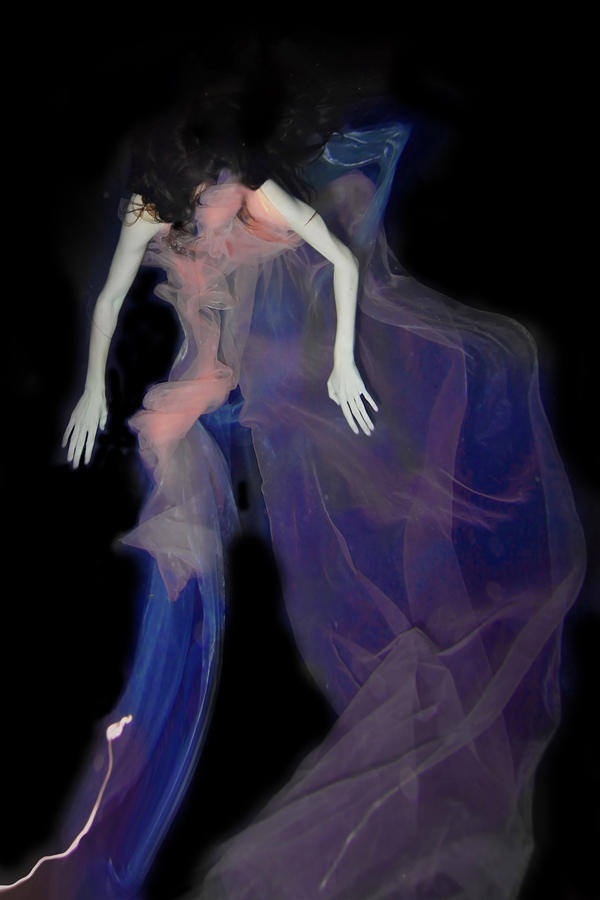Figure enveloped in blue and violet fabric