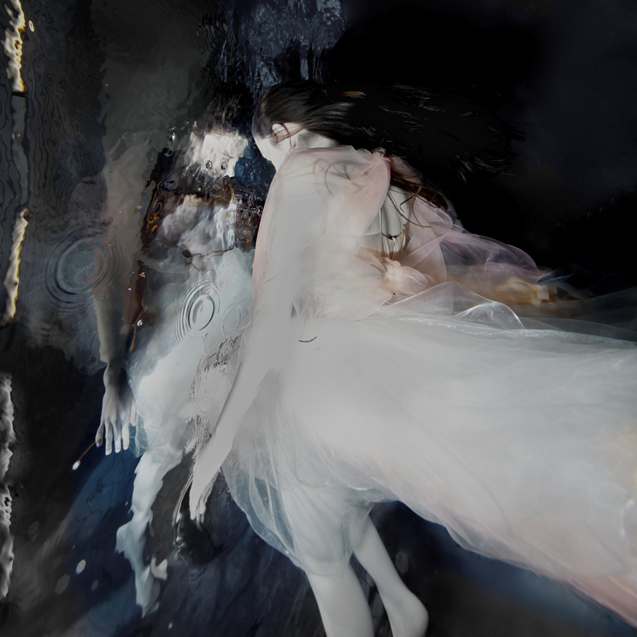 White-clad figure in a dark fluid scene