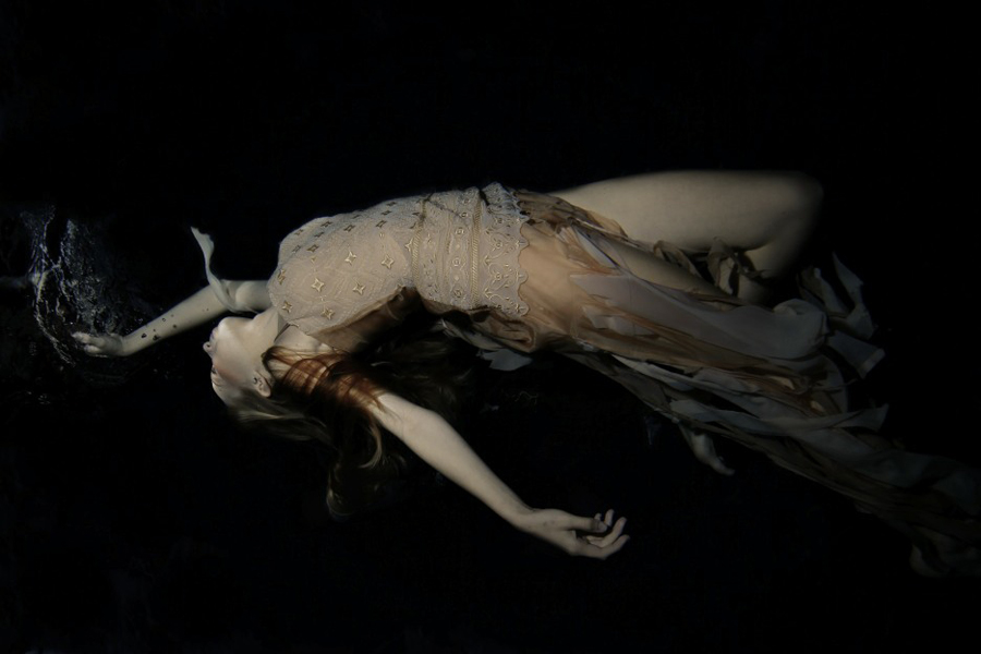 Reclining pale figure in a dark composition