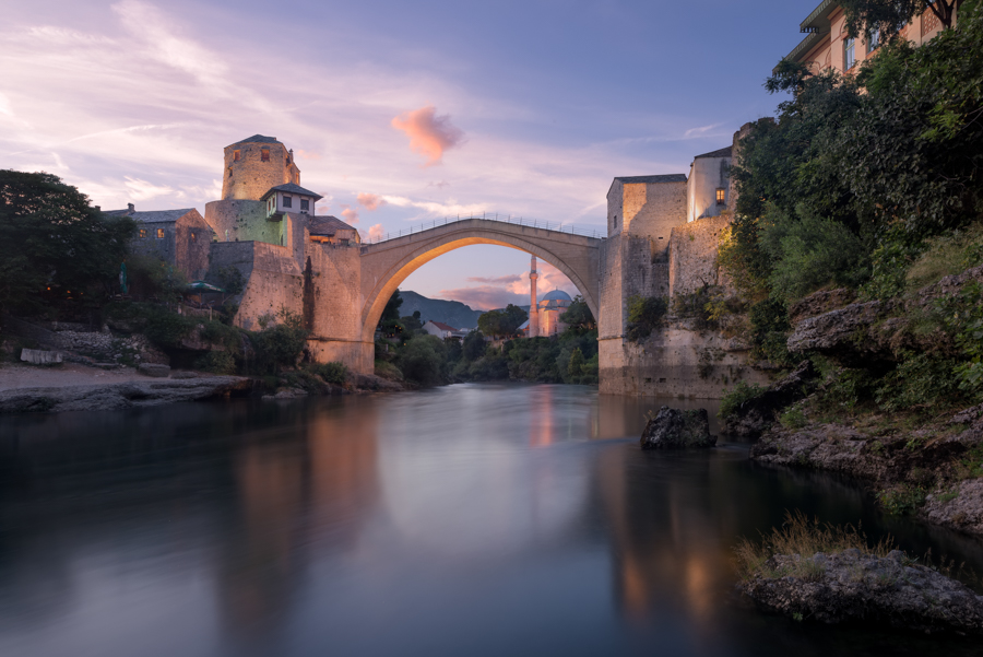 Stone bridge over a river at sunset