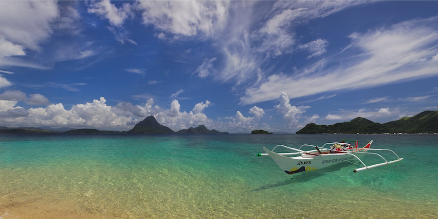 Outrigger boat on clear tropical water