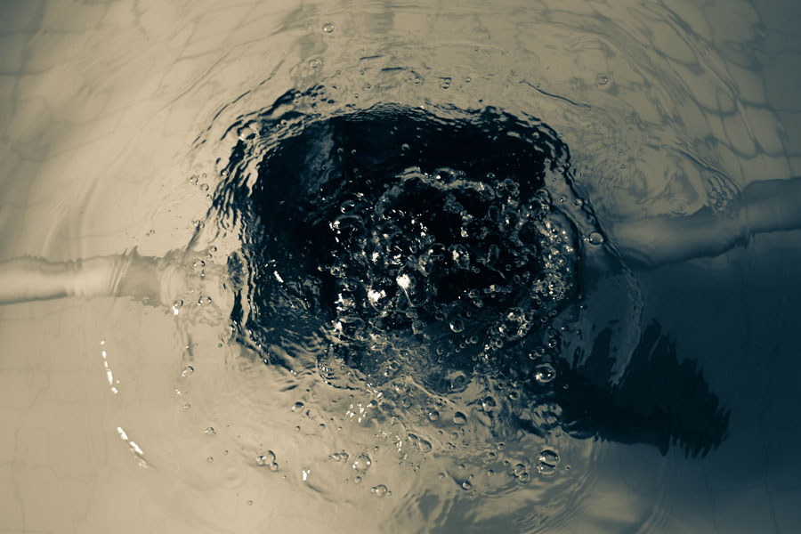 Person submerged beneath rippling water