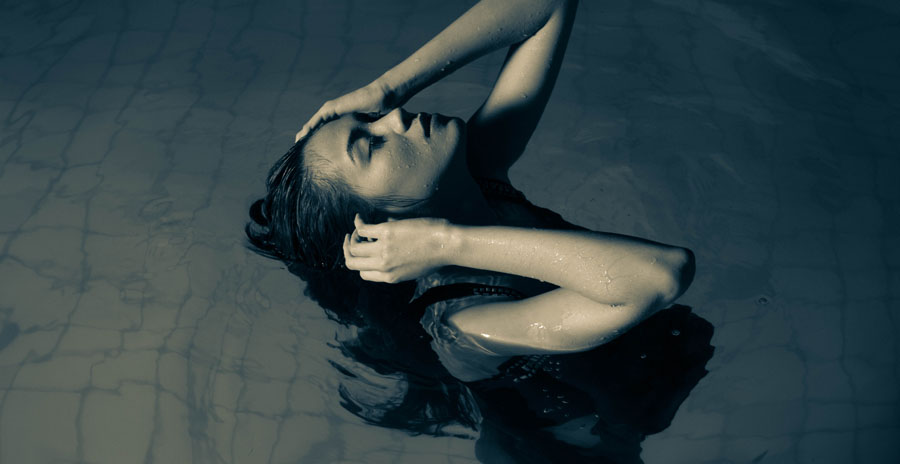 Person floating with face near the water surface