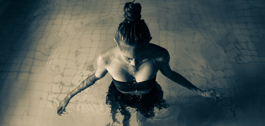 Person standing waist-deep in dark water