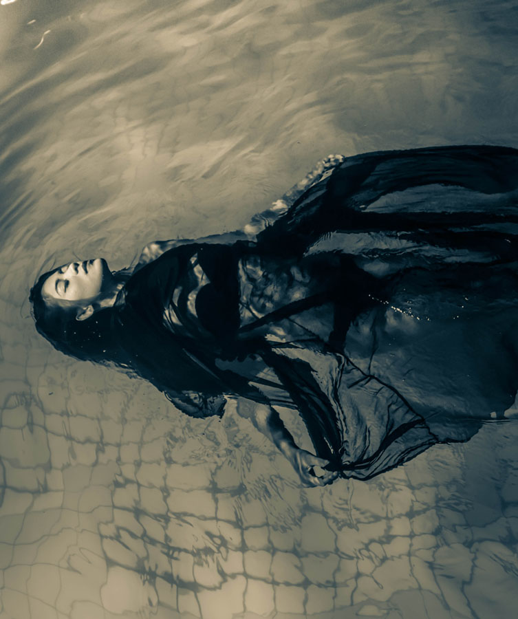 Person submerged in pale shallow water