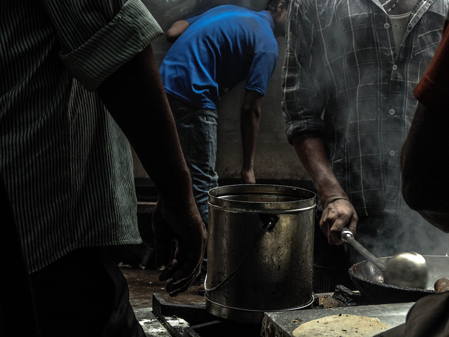 People preparing food at a street stall