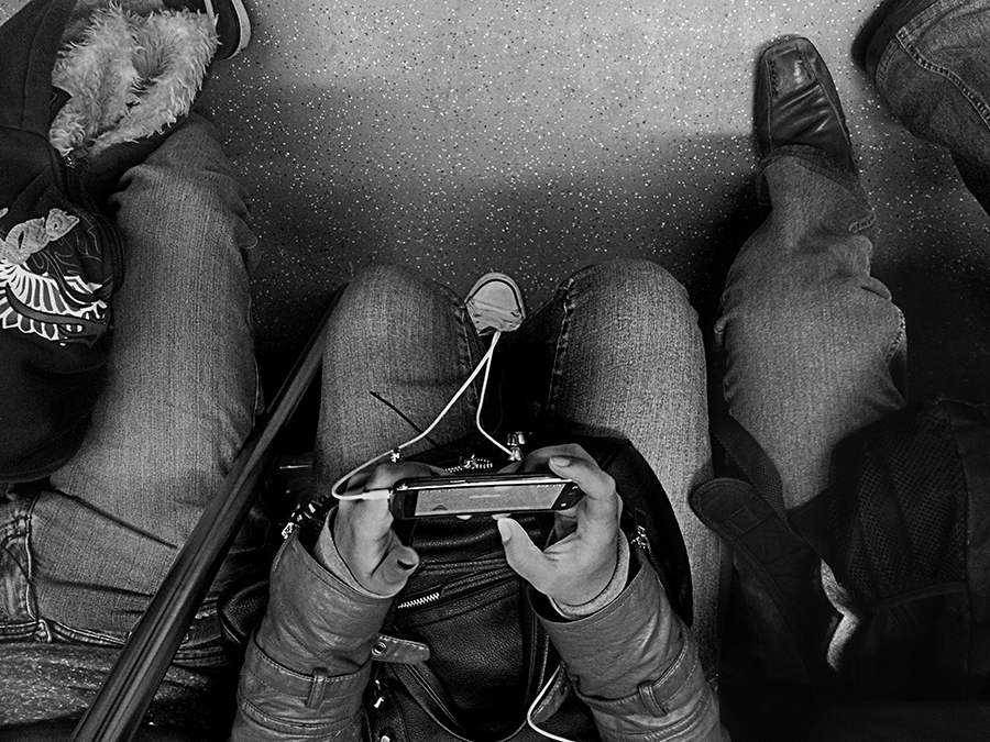 Train passenger holding a small camera