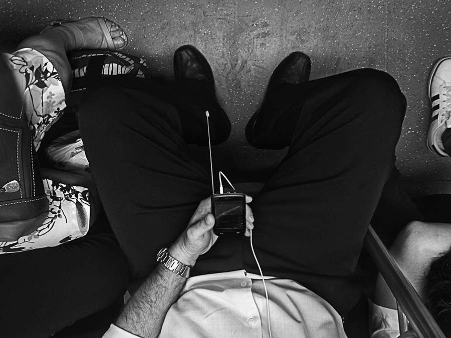 Passenger with earphones holding a phone