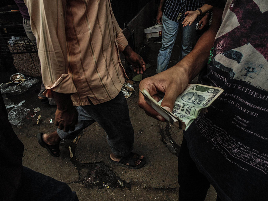 Hands exchanging money on a street