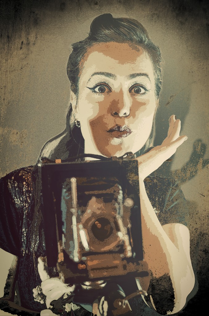 Catherine Rankovic posing with a vintage camera