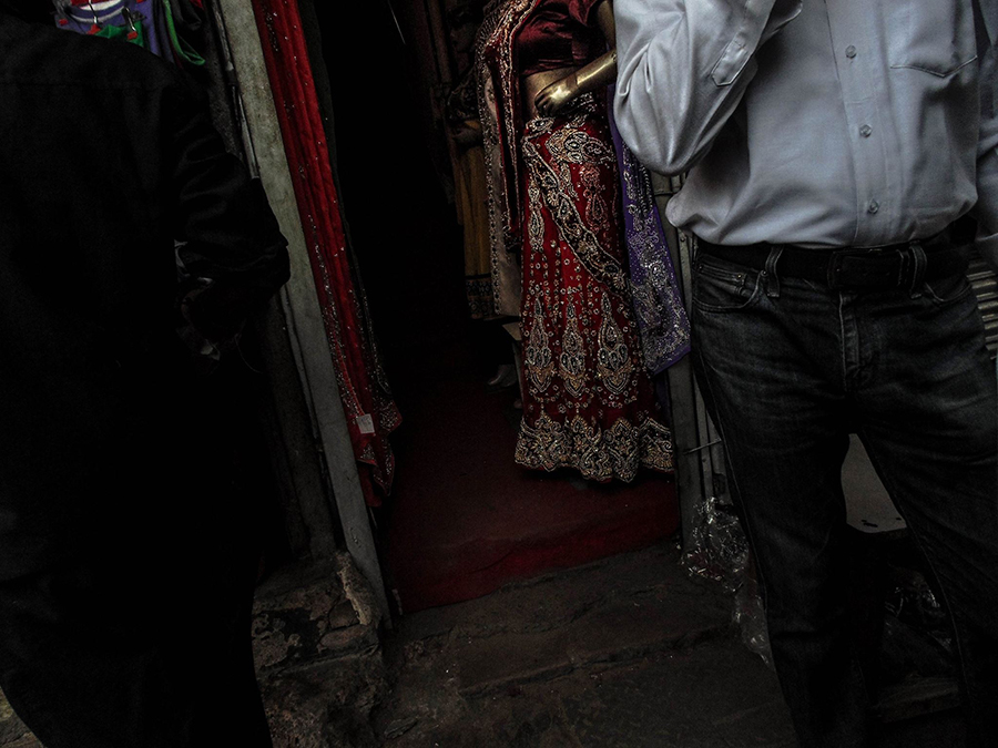 Candid scene of people walking past a doorway