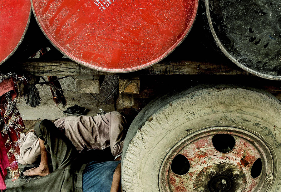 Person resting beneath a vehicle