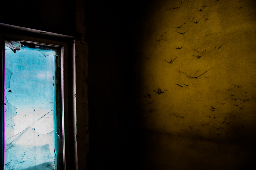 Sliver of blue sky beside a dark wall