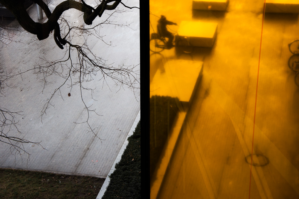 Yellow-lit shadows across a narrow street