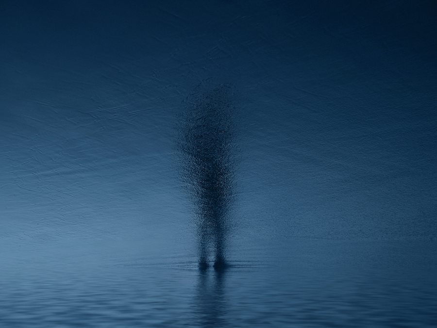 Blurred figure standing in dark water