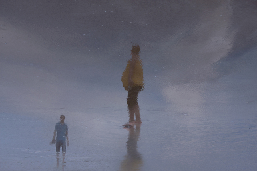 Solitary figure in a misty shore scene