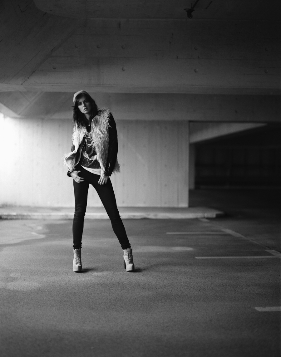 Black-and-white portrait of a person in a parking garage