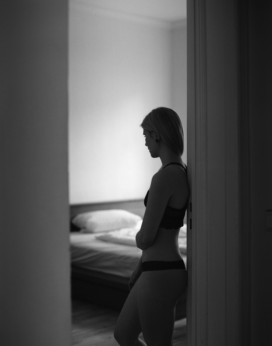 Woman seated in profile beside a window