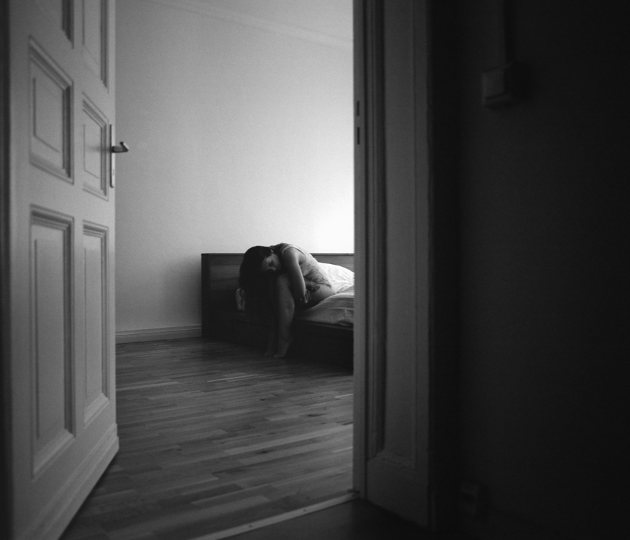 Quiet bedroom scene viewed through a doorway