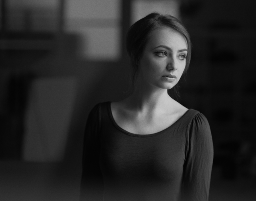 Woman looking aside in a dark portrait