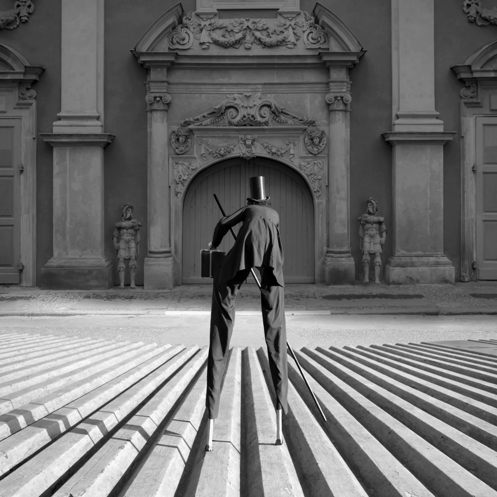 Figure standing in an arched stone doorway