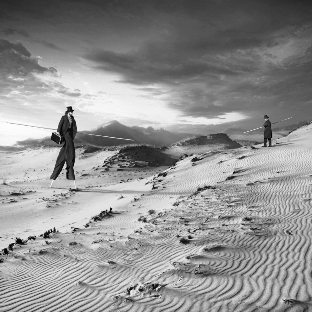 Figures crossing rippled sand dunes