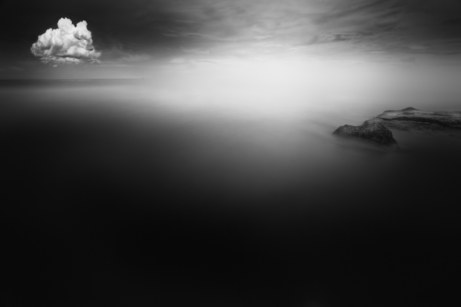 Small cloud reflected in smooth water