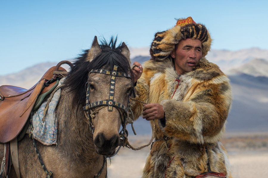 Rider in fur clothing with a horse