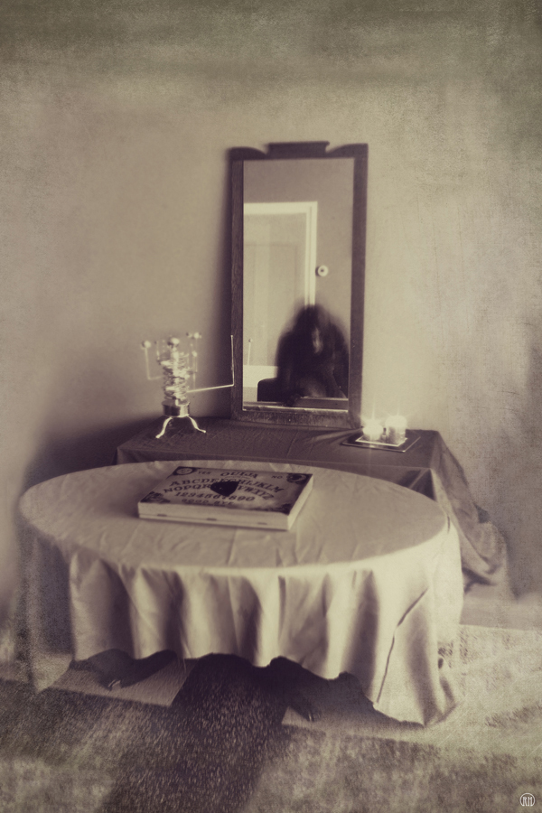 Ghostly figure at a table in an old room