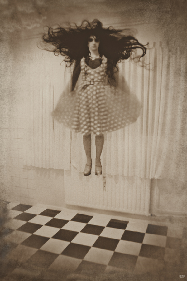 Girl-like figure against a patterned wall