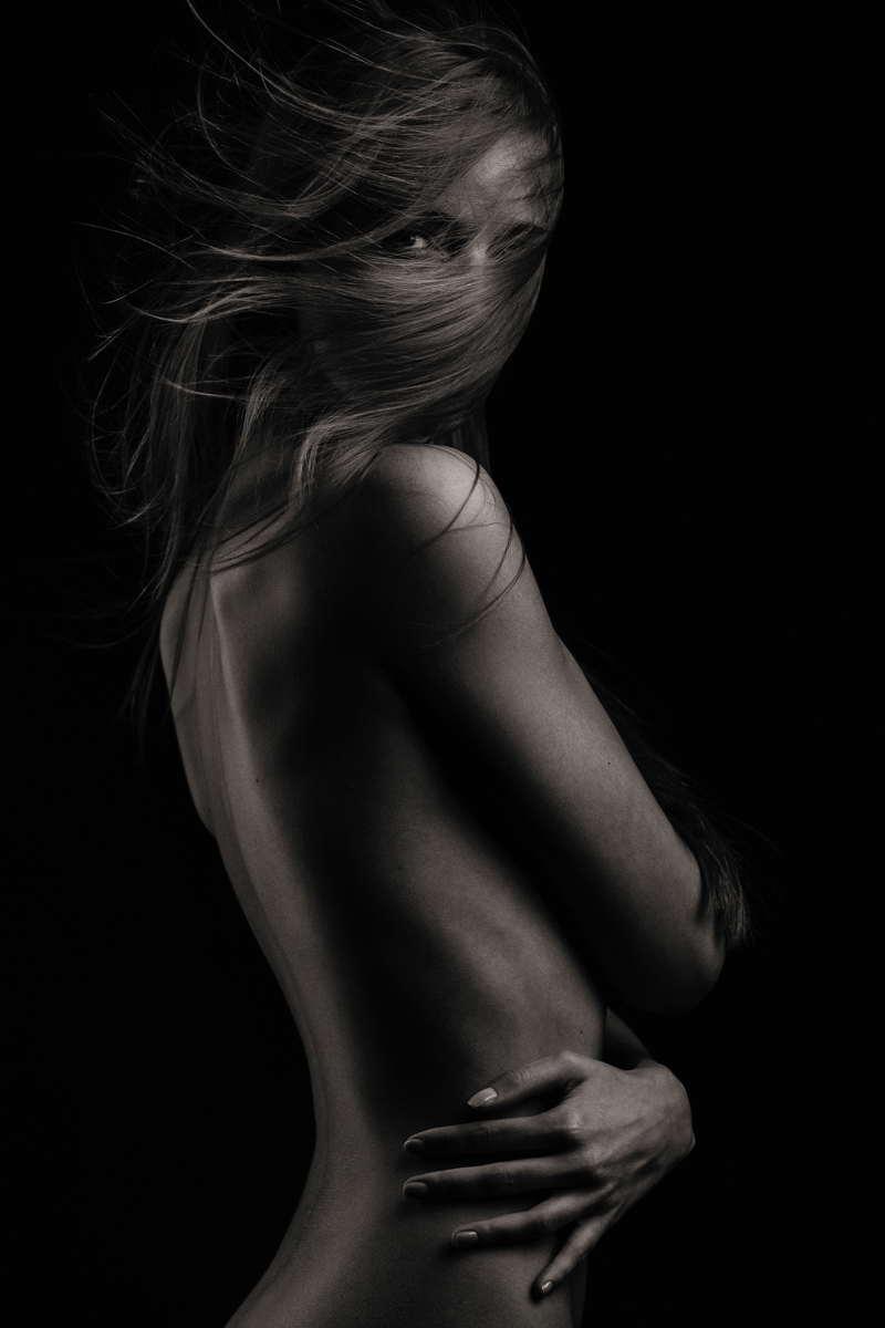 Woman with flowing hair in a low-key portrait
