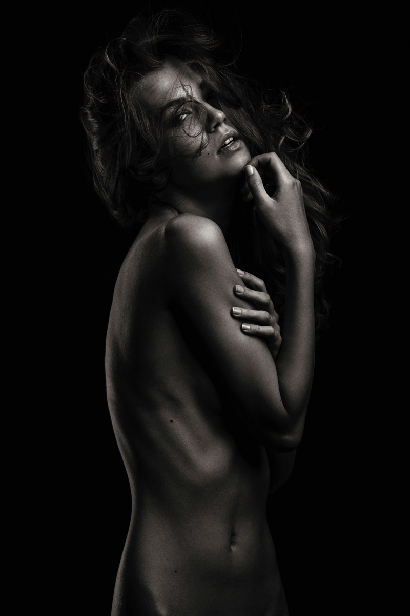 Woman looking toward the camera in shadow